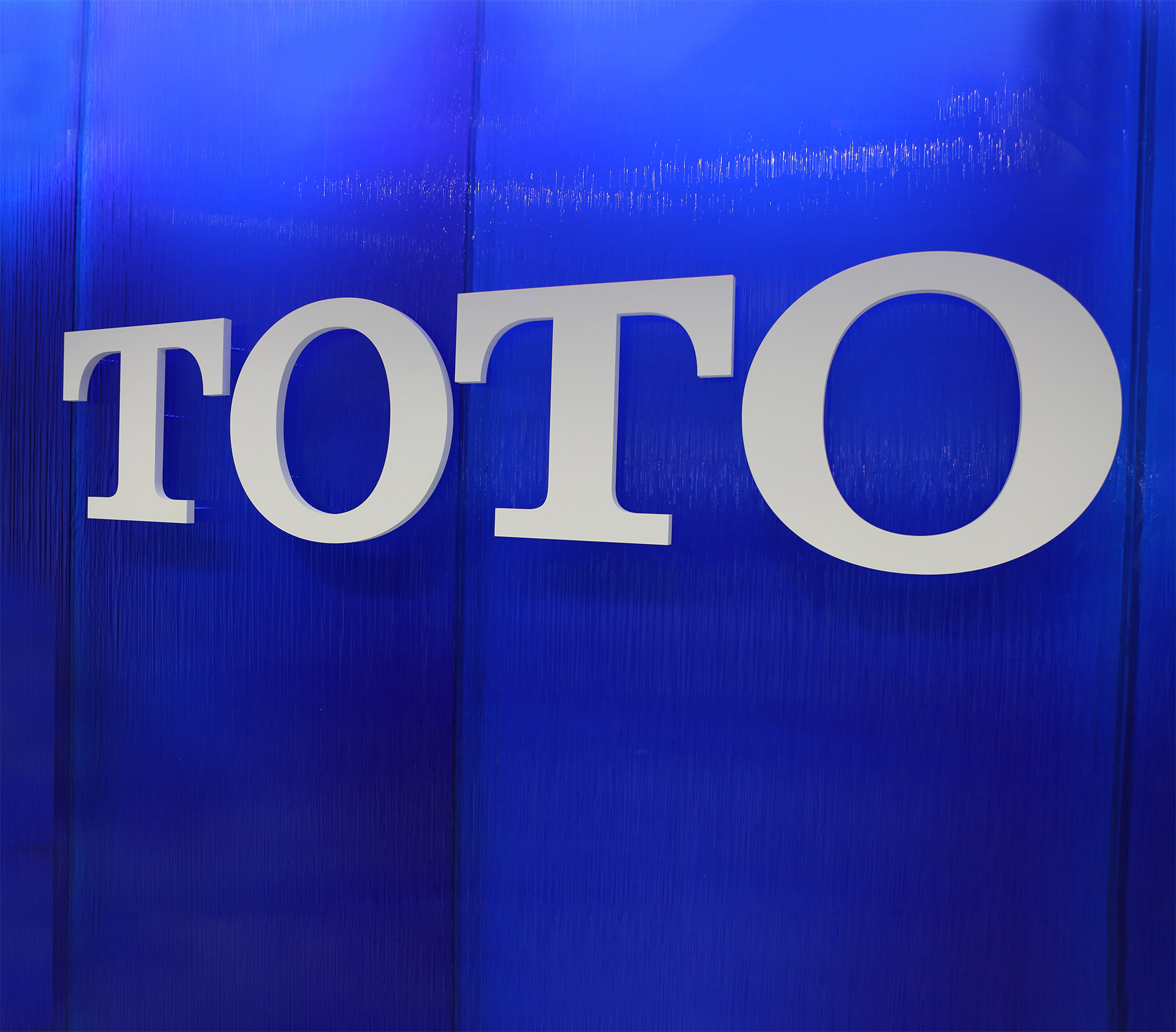 TOTO signage on blue textured glass